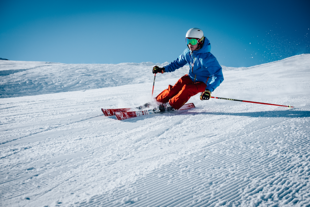 Skier carving through fresh powder snow in the Alps